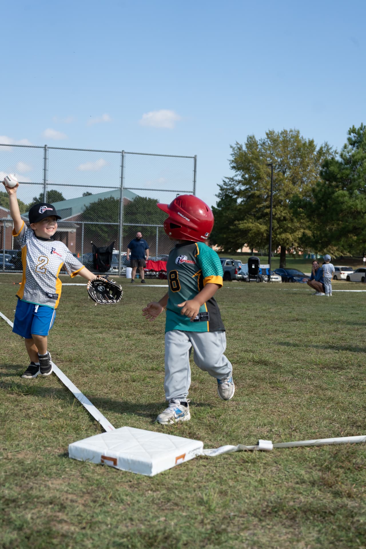Two tee ball players at first base