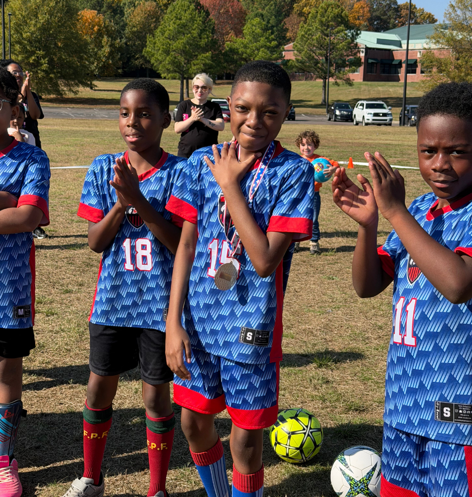 Young athletes celebrating with medals after a game